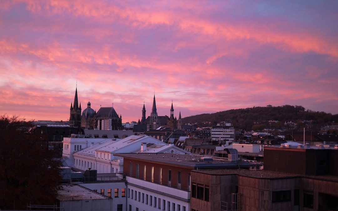 a view of a city at sunset with a pink sky