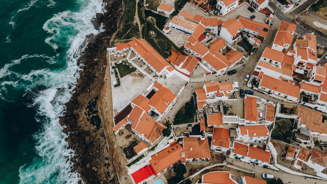 an aerial view of a small village by the ocean