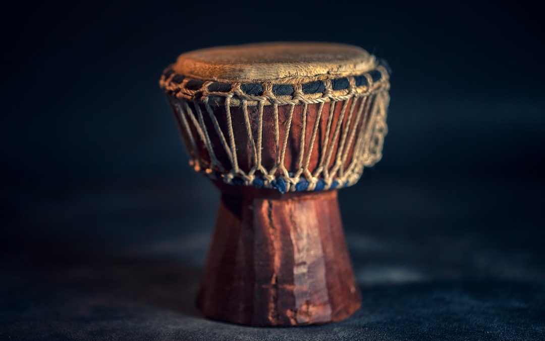 selective focus photography of brown djembe instrument