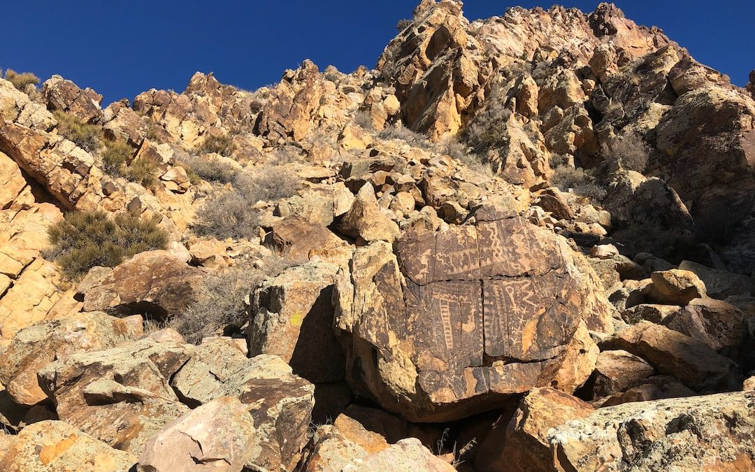 a rocky mountain with a blue sky