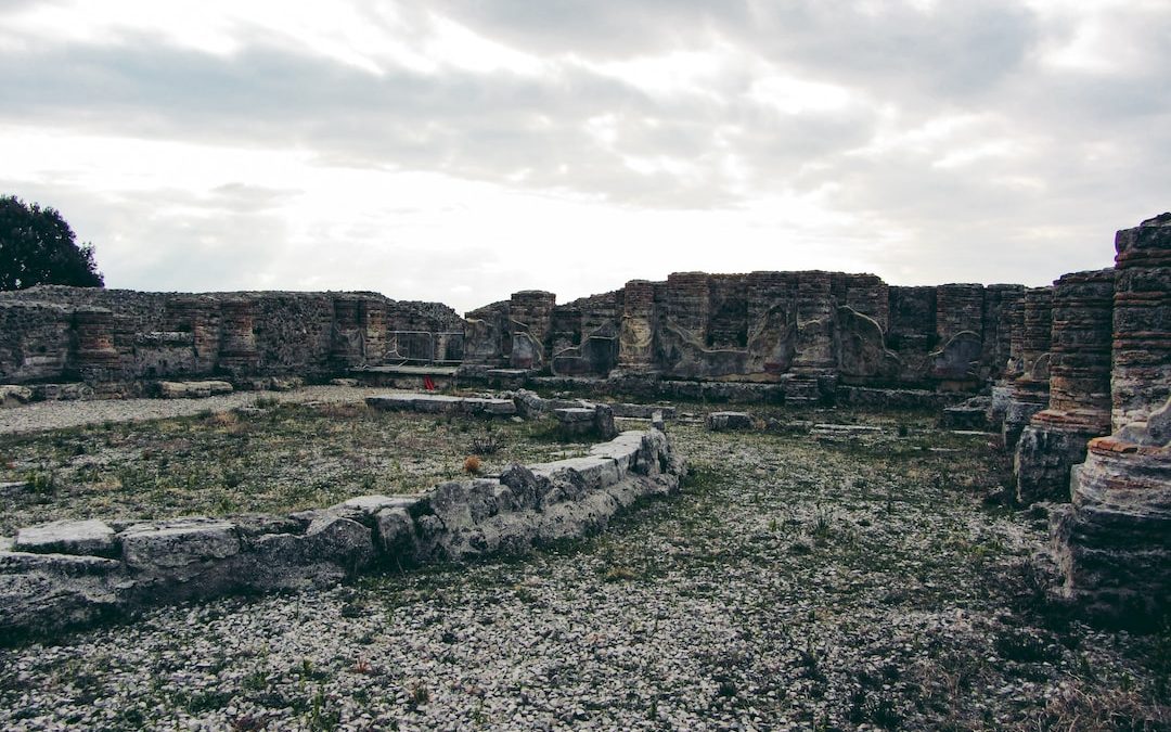 the ruins of a roman city under a cloudy sky