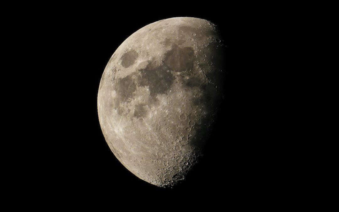 a close up of the moon in the dark sky