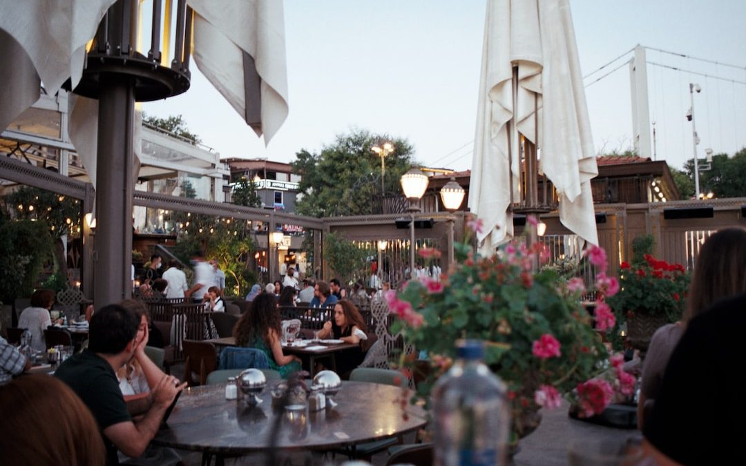 a group of people sitting at a table in a restaurant