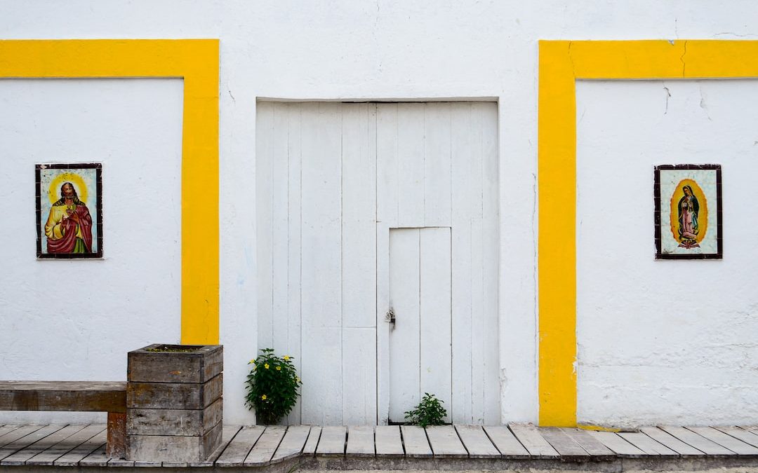 a yellow and white building with a white door