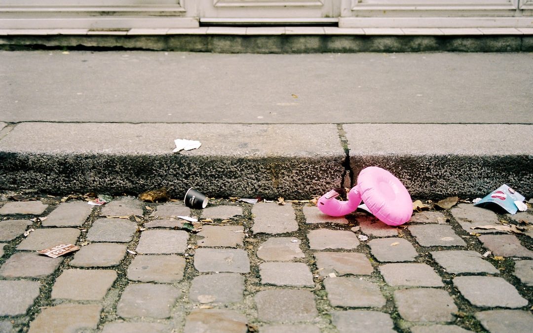 pink balloon on grey concrete pavement