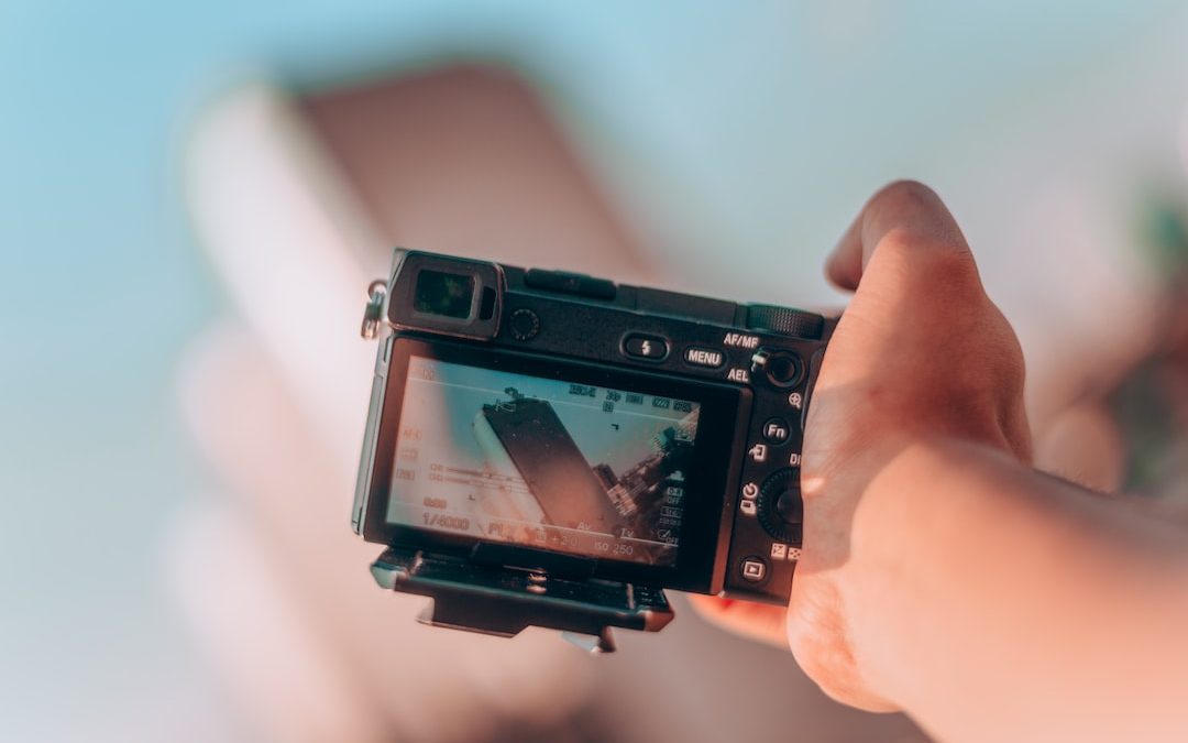 person pointing camera on high rise building