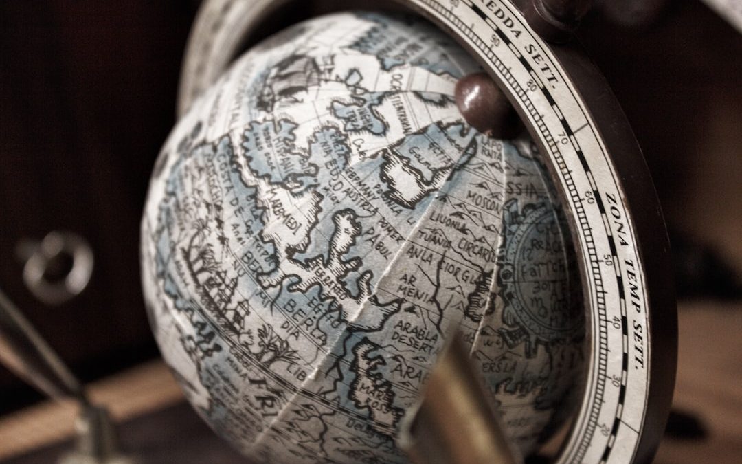 selective focus photography of white and gray desk globe