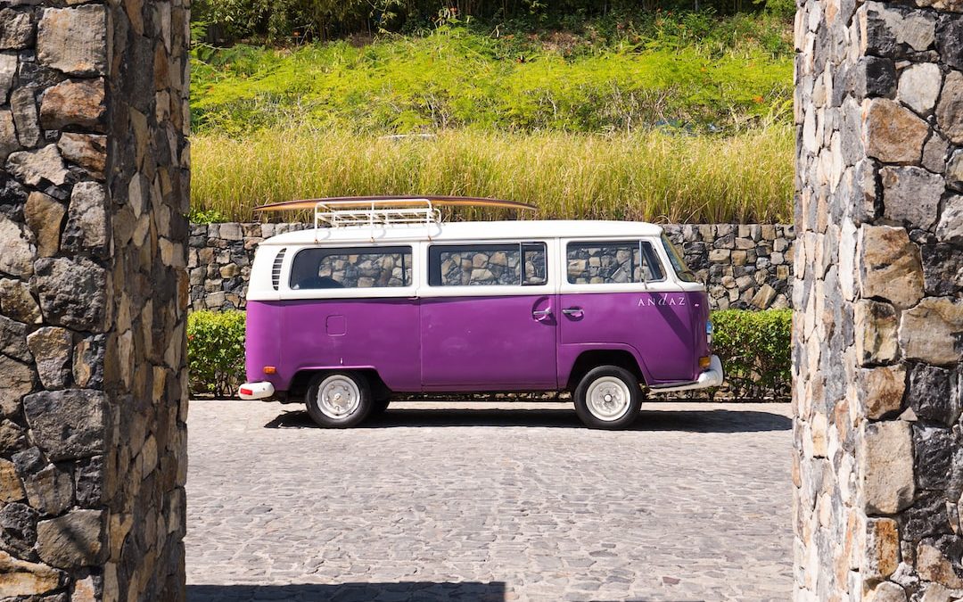 purple and white volkswagen t-2 on gray concrete road during daytime