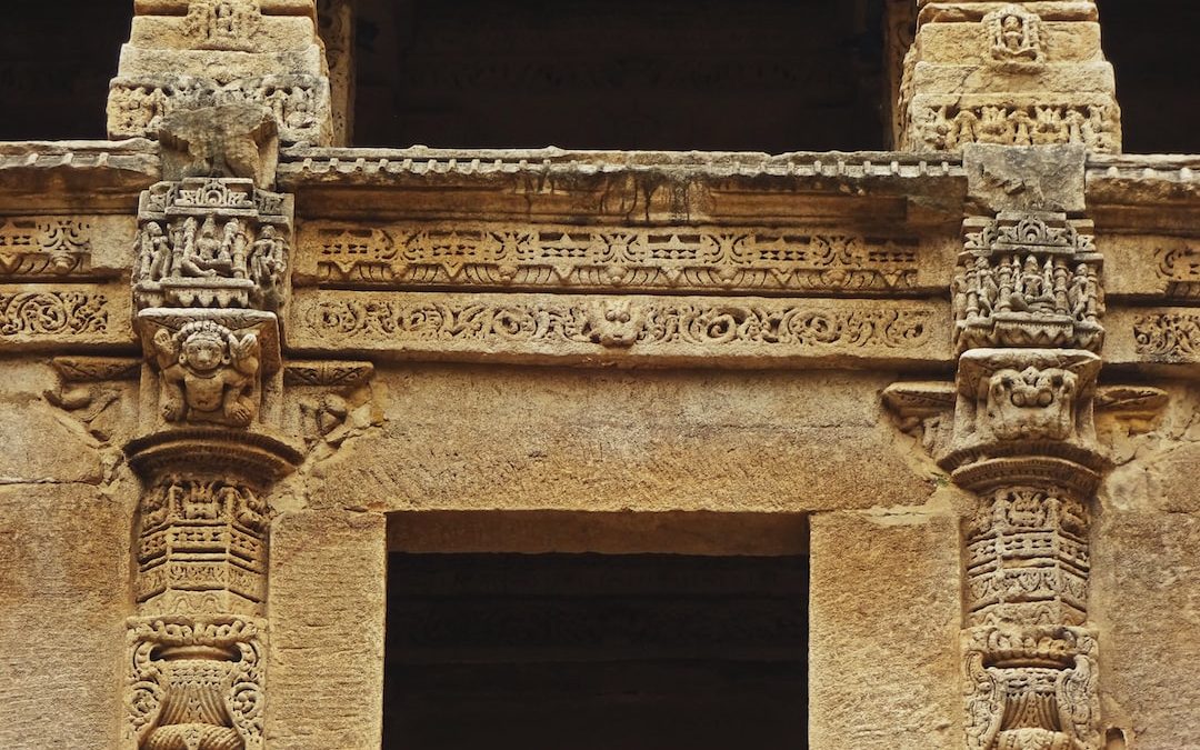 a close up of a doorway with carvings on it