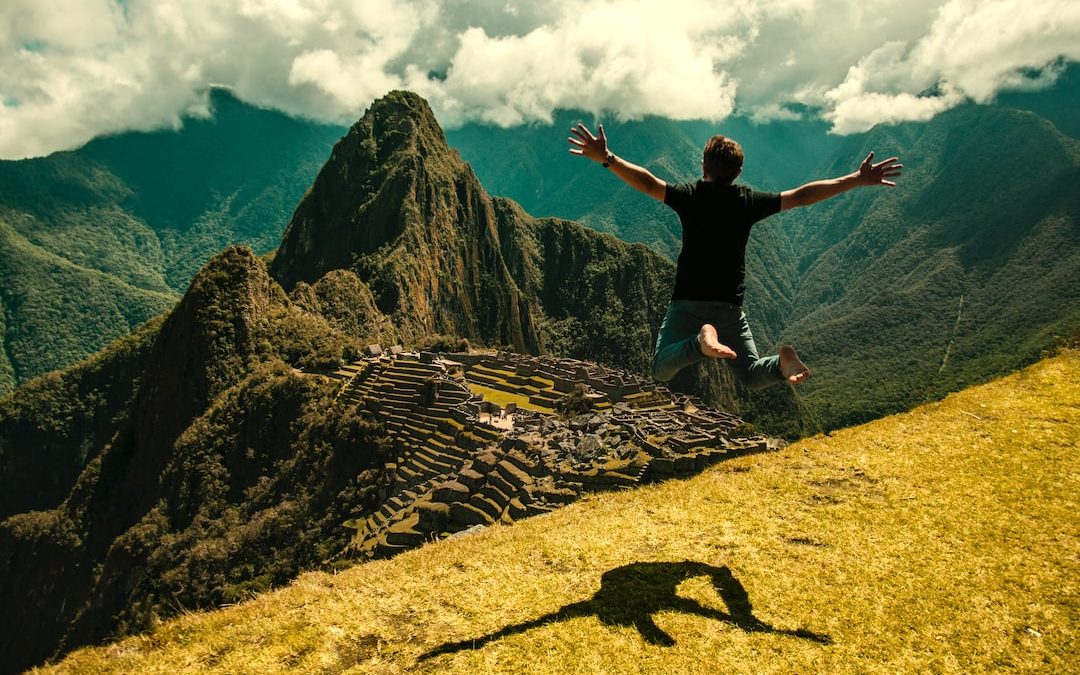 man jumping in green open field