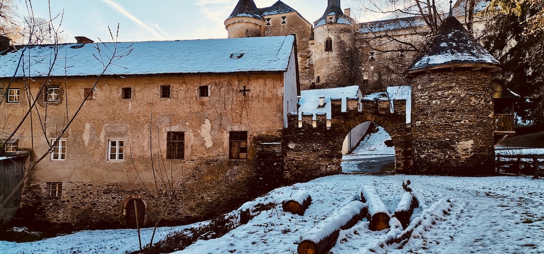 a castle in the snow with a bridge over it