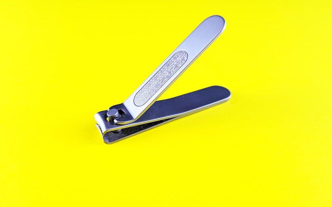 a pair of scissors sitting on top of a yellow surface