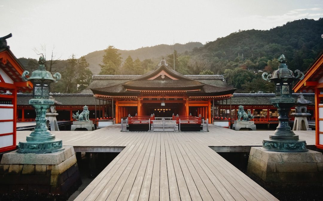 brown wooden gazebo near green trees during daytime