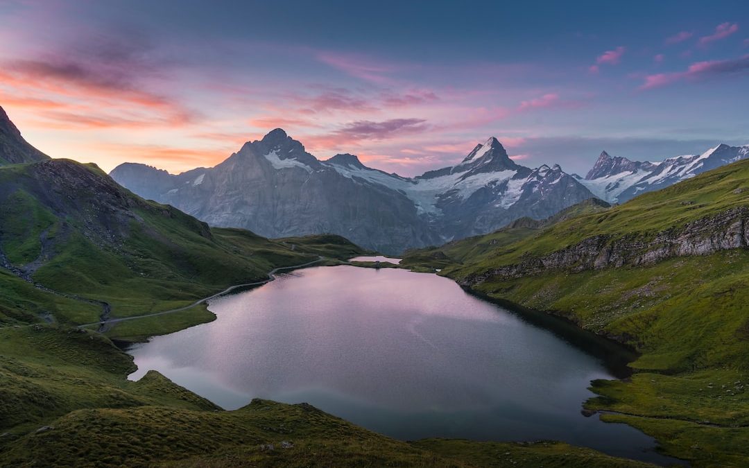 lake in the middle of green mountains