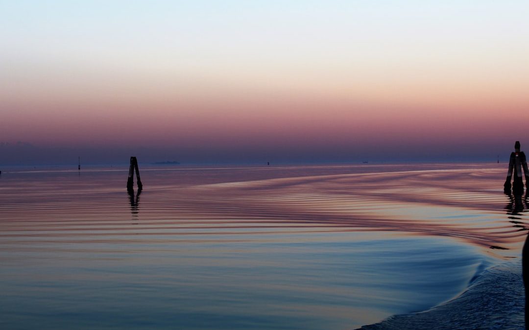 wavy body of water during golden hour