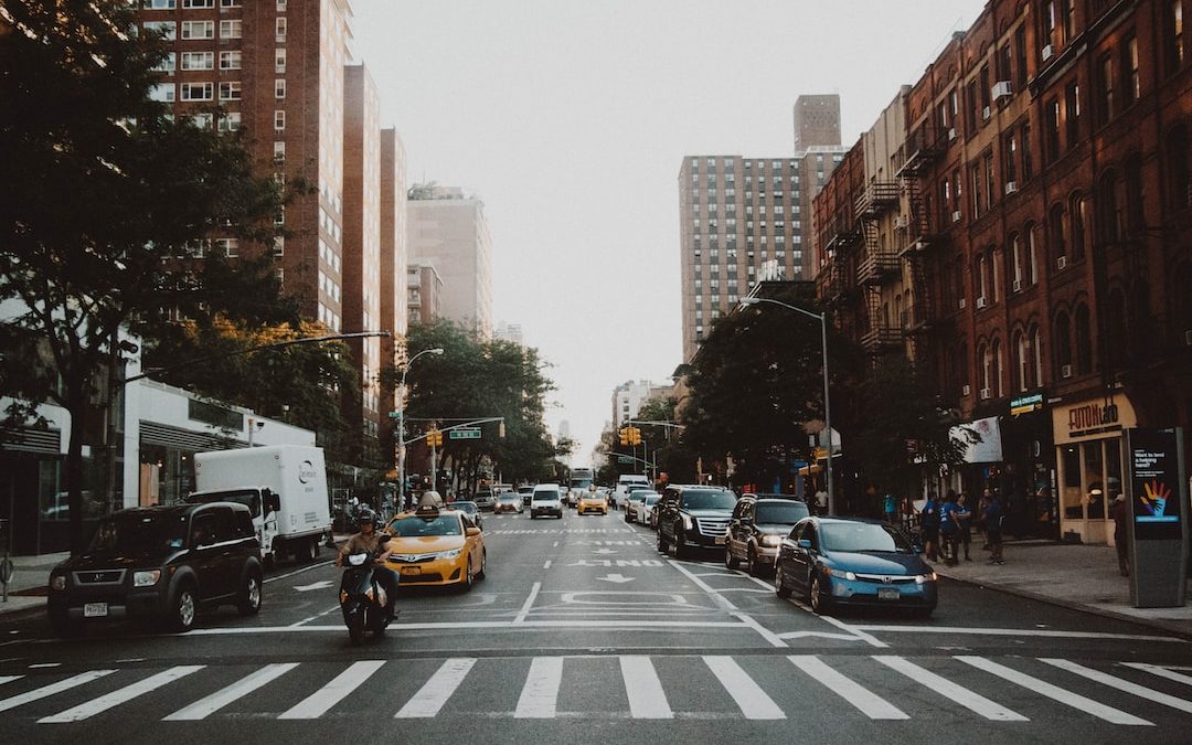 photo of cars on road near city building