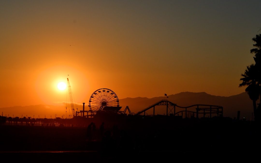 silhouette of ferris wheel during sunset