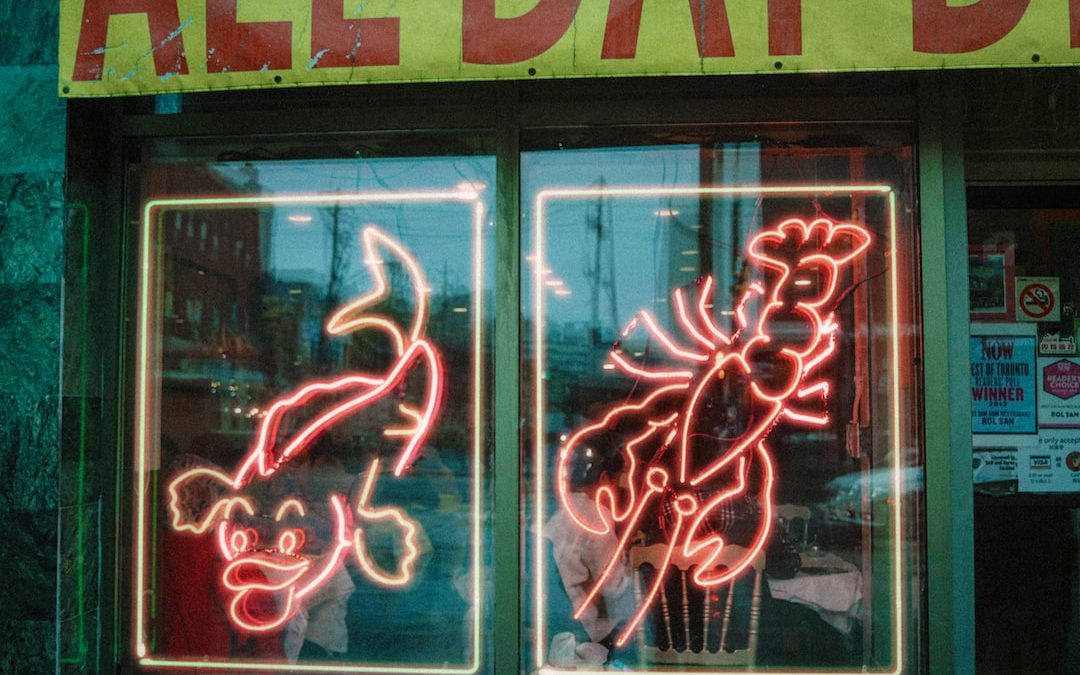 a neon sign in the window of a restaurant