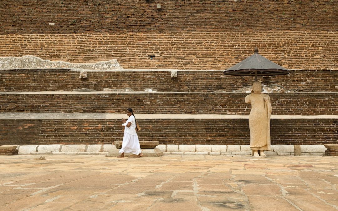 woman in white dress standing on brown concrete floor during daytime