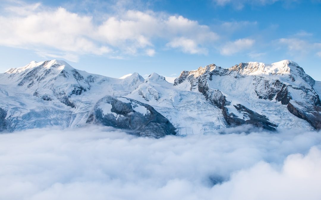 snow-capped mountain with sea of clouds