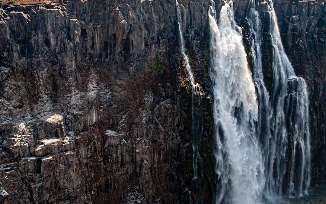 a very tall waterfall with lots of water coming out of it