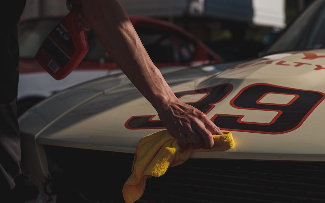 closeup photo of person wiping white racing card