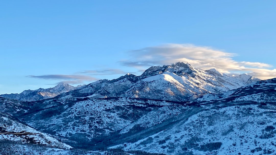 a snow covered mountain range with a sky background
