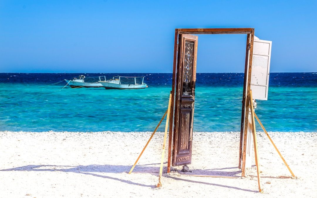 brown wooden frame on white sand beach during daytime