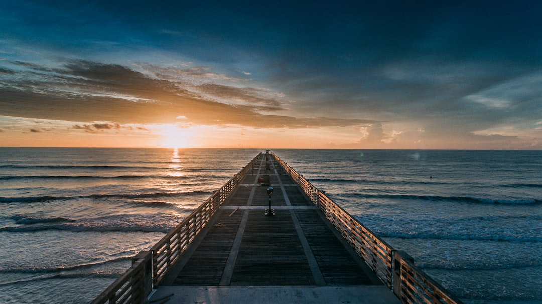 empty dock at the beach during golden hour