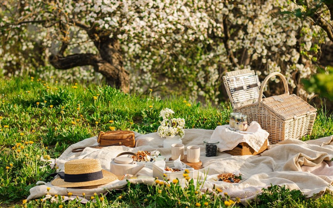 a picnic table with a basket and flowers