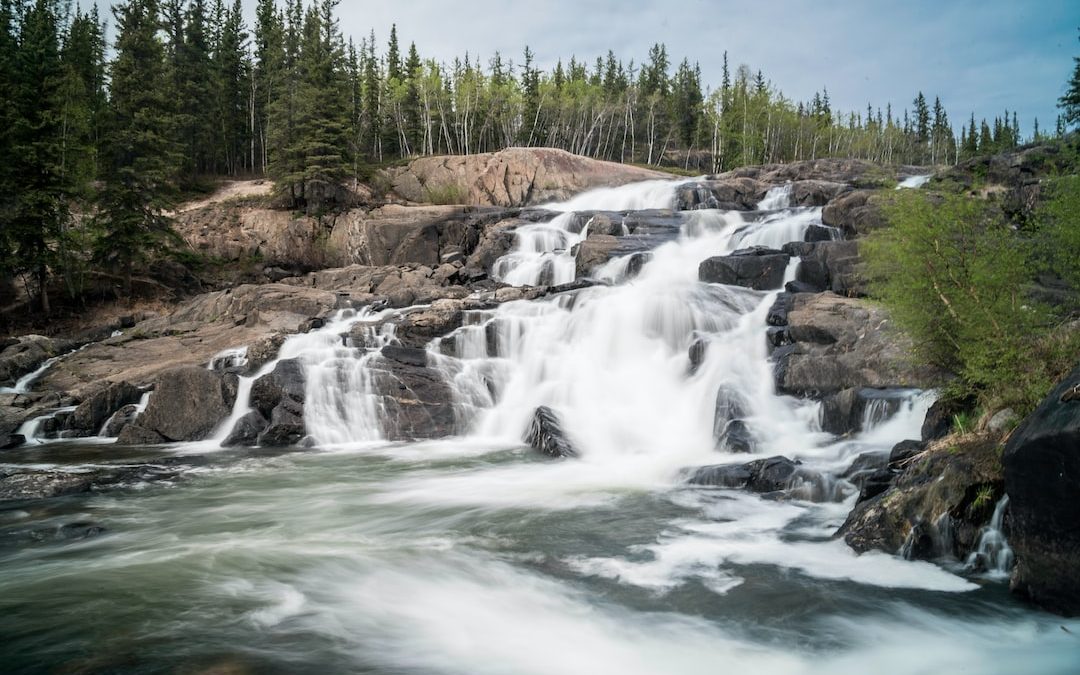 time lapse photography of flowing multi-step waterfall