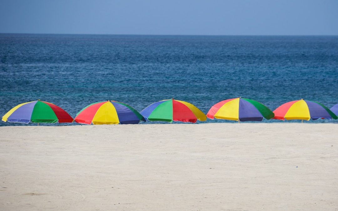 five parasols at the shore during day