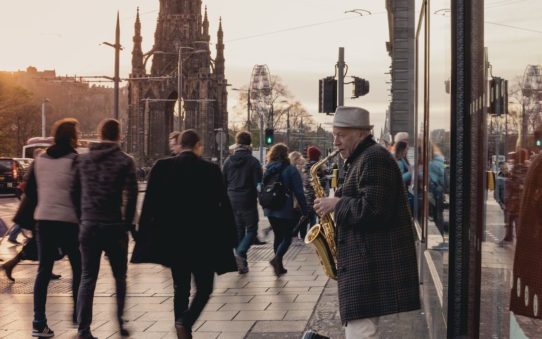 person playing saxophone in front of people