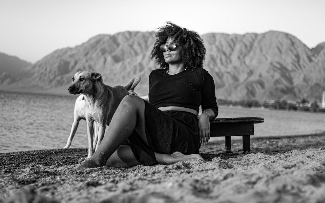 a woman sitting on a bench with a dog