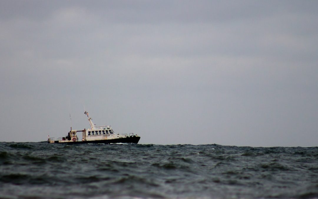 white fishing boat on sea