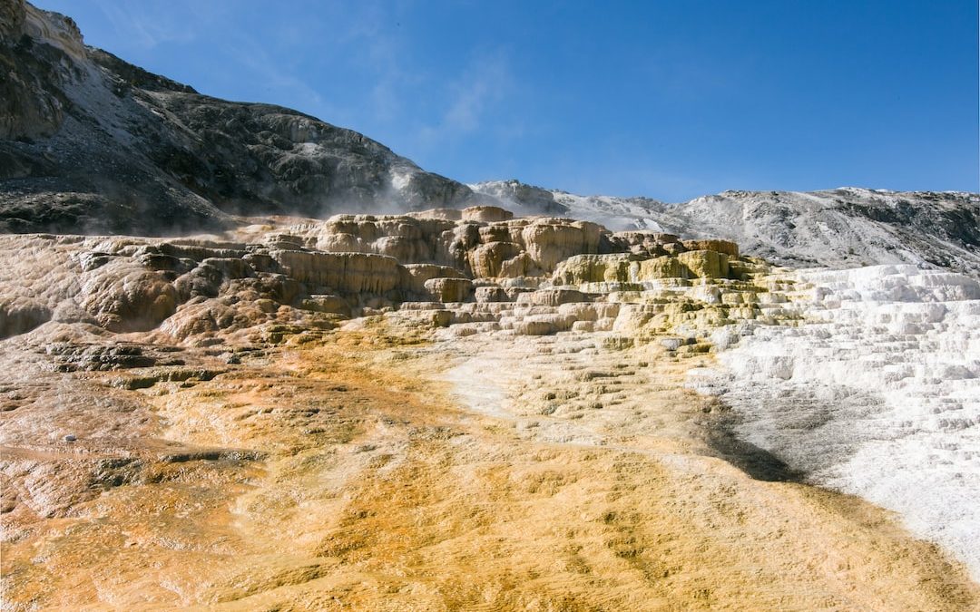 gray rocky mountain under blue sky during daytime