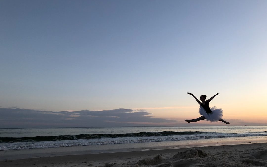 silhouette of ballerina jumping on air