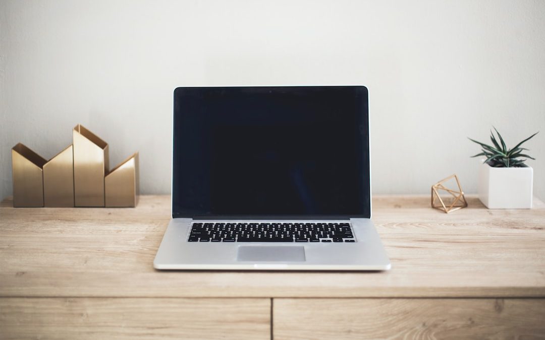 MacBook Pro on top of brown table