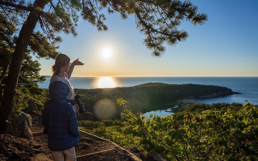 a woman and a man looking at the sun