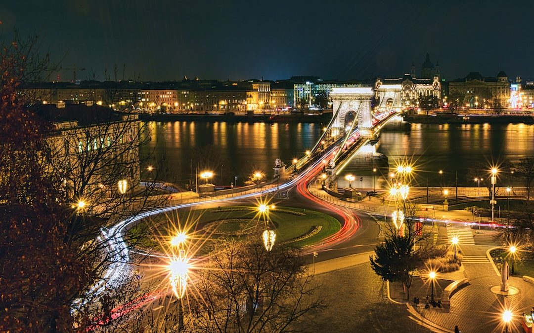 a night time view of a city with a bridge