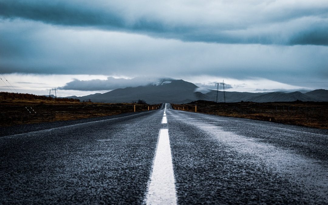 gray asphalt road under gray cloudy sky during daytime