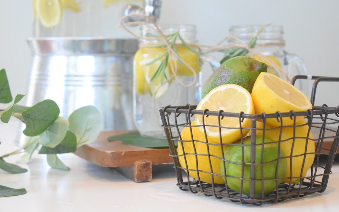 green lemon fruit in black metal basket