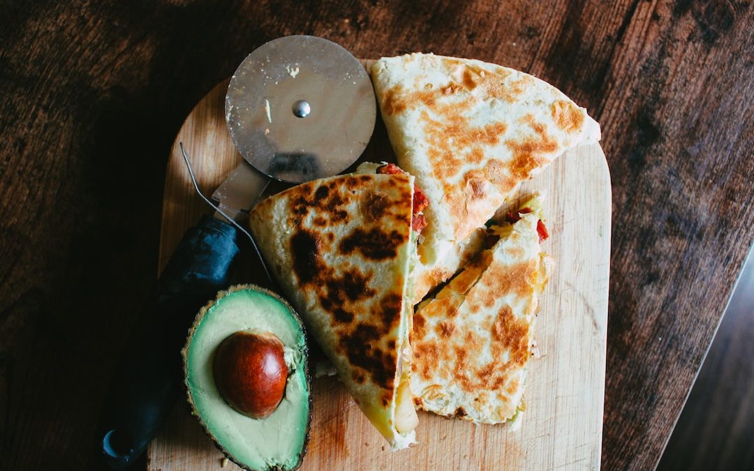 sliced pizza on brown wooden table