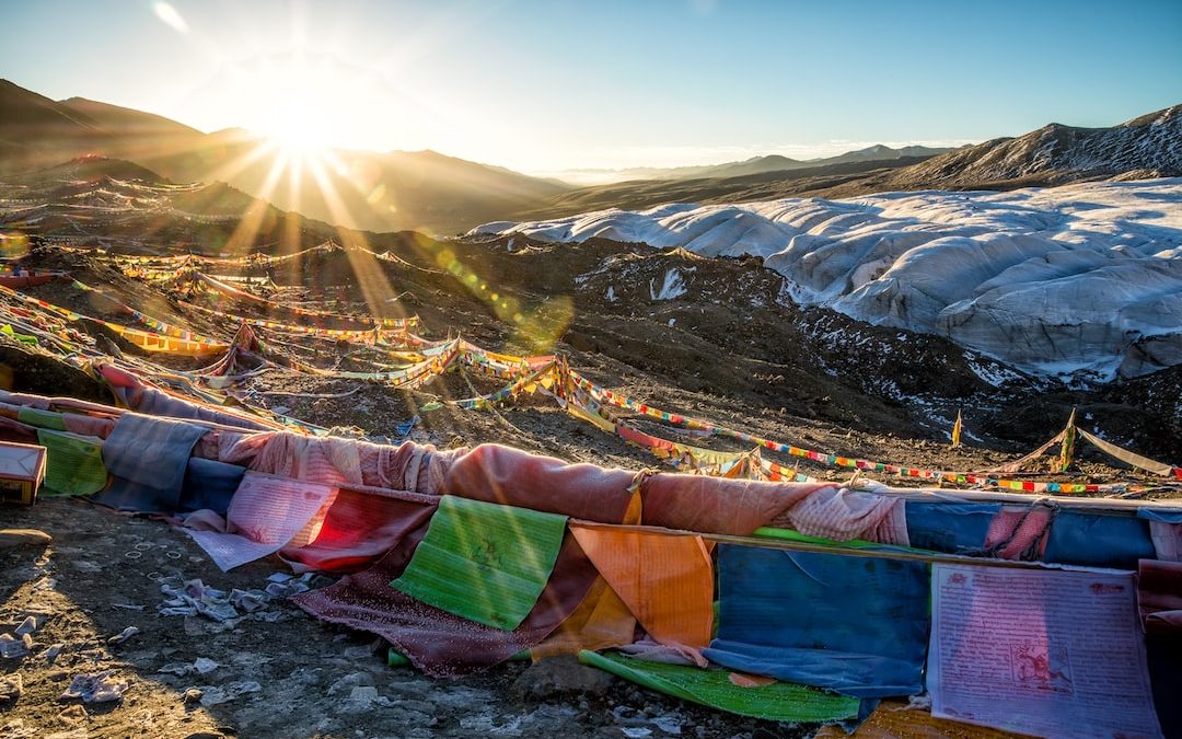 multicolored lines on hill under clear sky during sunrise