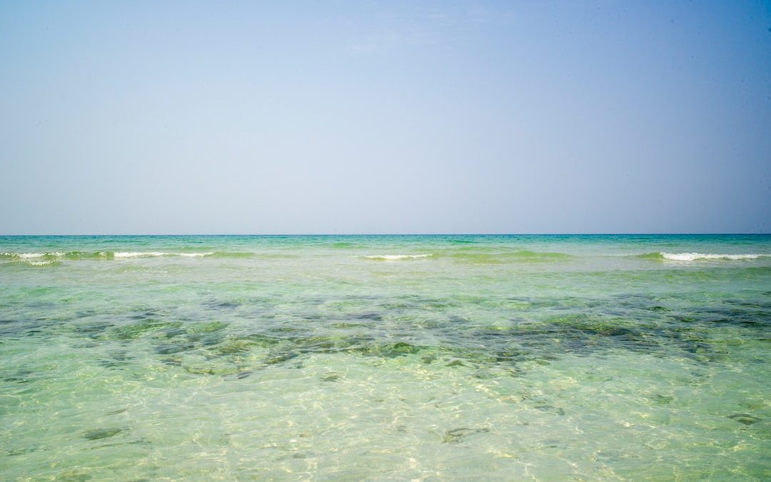 blue ocean water under blue sky during daytime