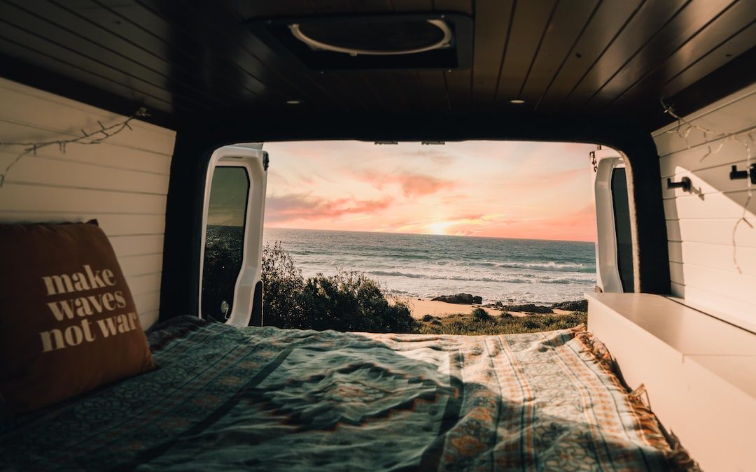 a bedroom with a bed and a view of the ocean