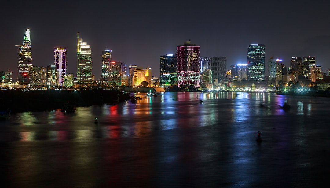 a city at night with lights reflecting off the water