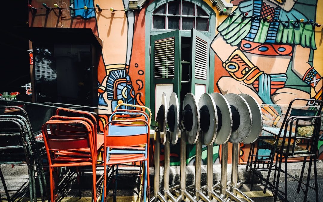 assorted-color metal chairs outside building wall art