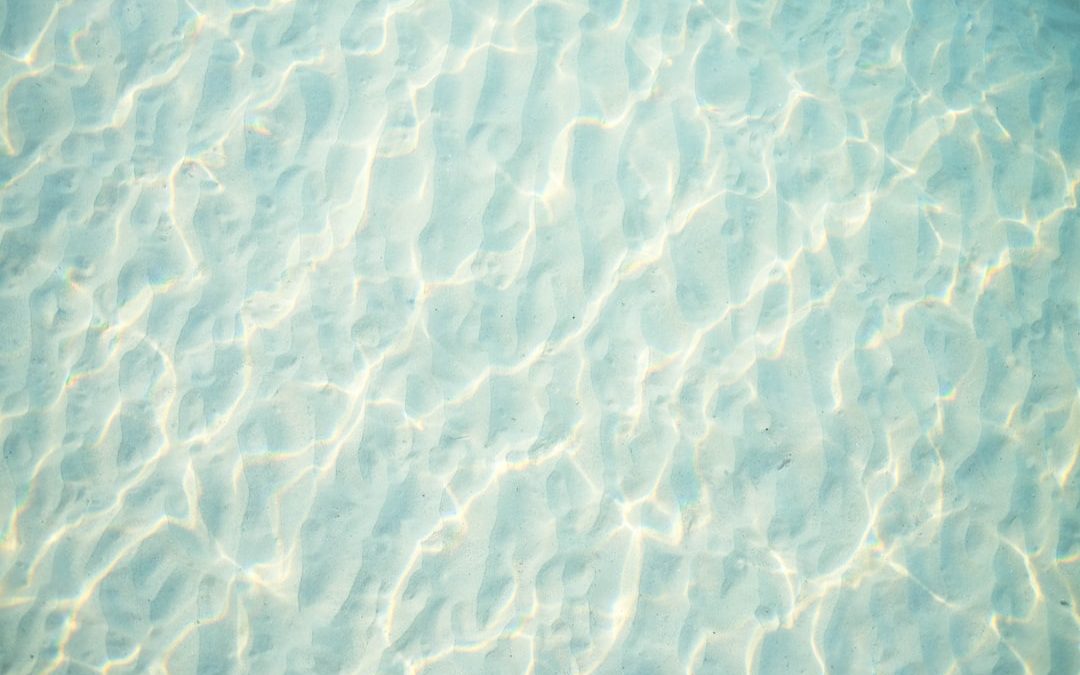 a view of the water from the bottom of a swimming pool
