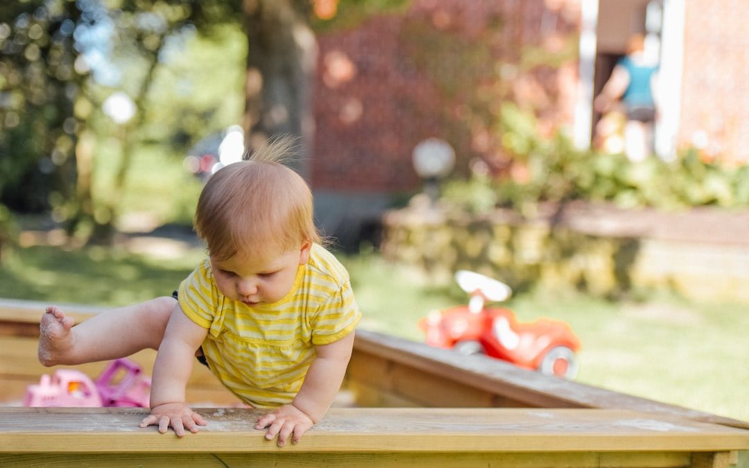 baby trying to get out of his crib